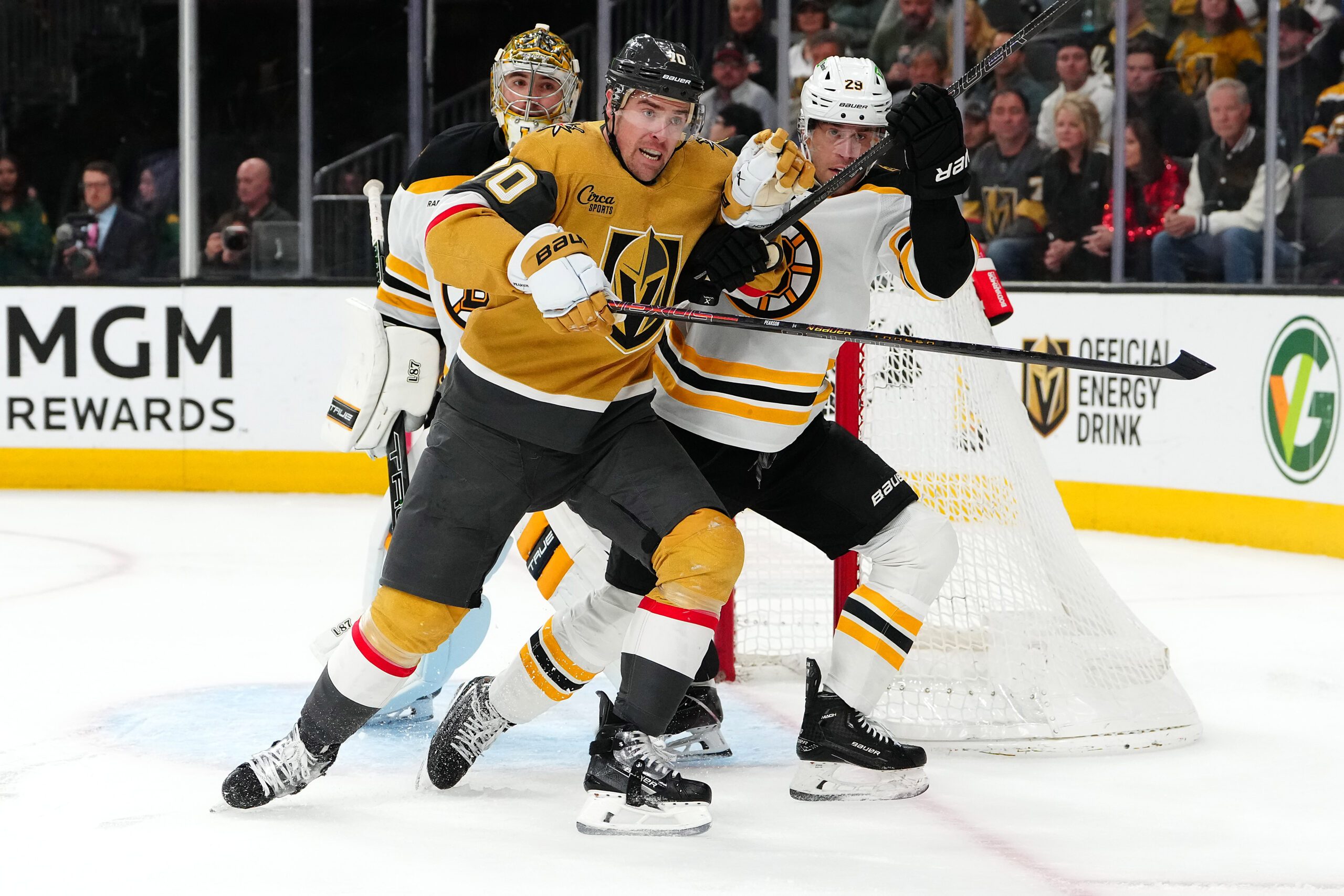 Mar 20, 2025; Las Vegas, Nevada, USA; Vegas Golden Knights left wing Tanner Pearson (70) attempts to skate past Boston Bruins defenseman Parker Wotherspoon (29) in front of Boston Bruins goaltender Jeremy Swayman (1) during the second period at T-Mobile Arena. Mandatory Credit: Stephen R. Sylvanie-Imagn Images