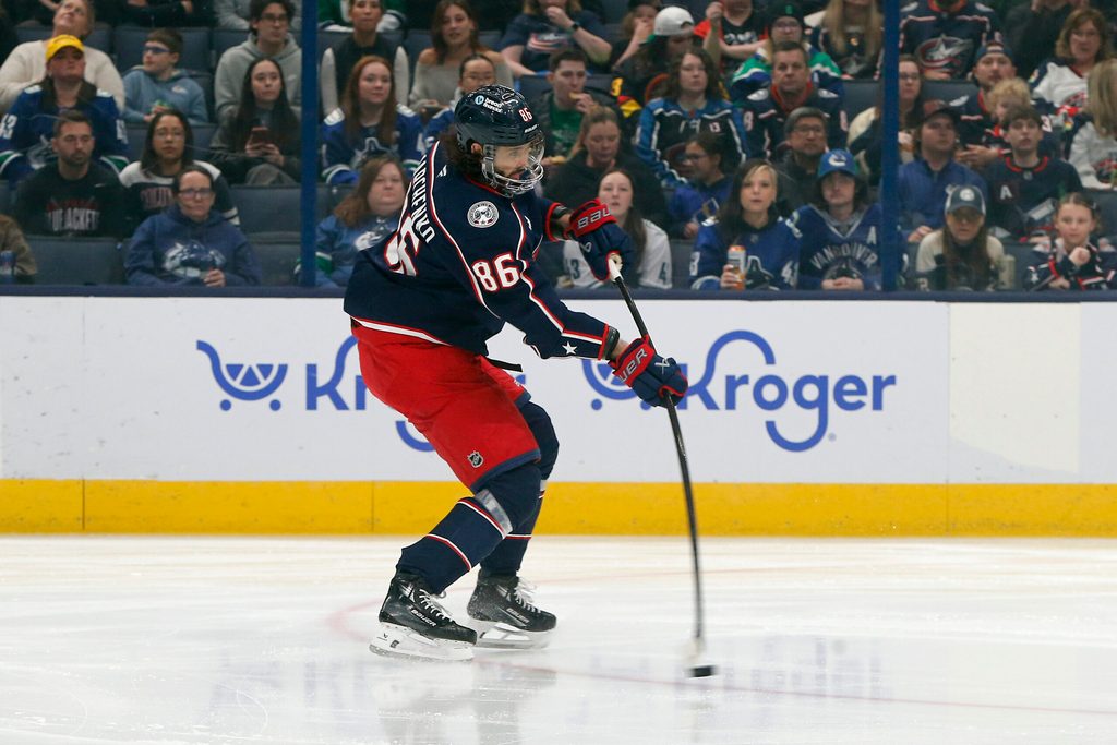 Mar 28, 2025; Columbus, Ohio, USA; Columbus Blue Jackets right wing Kirill Marchenko (86) wrists a shot on goal against the Vancouver Canucks during the first period at Nationwide Arena. Mandatory Credit: Russell LaBounty-Imagn Images
