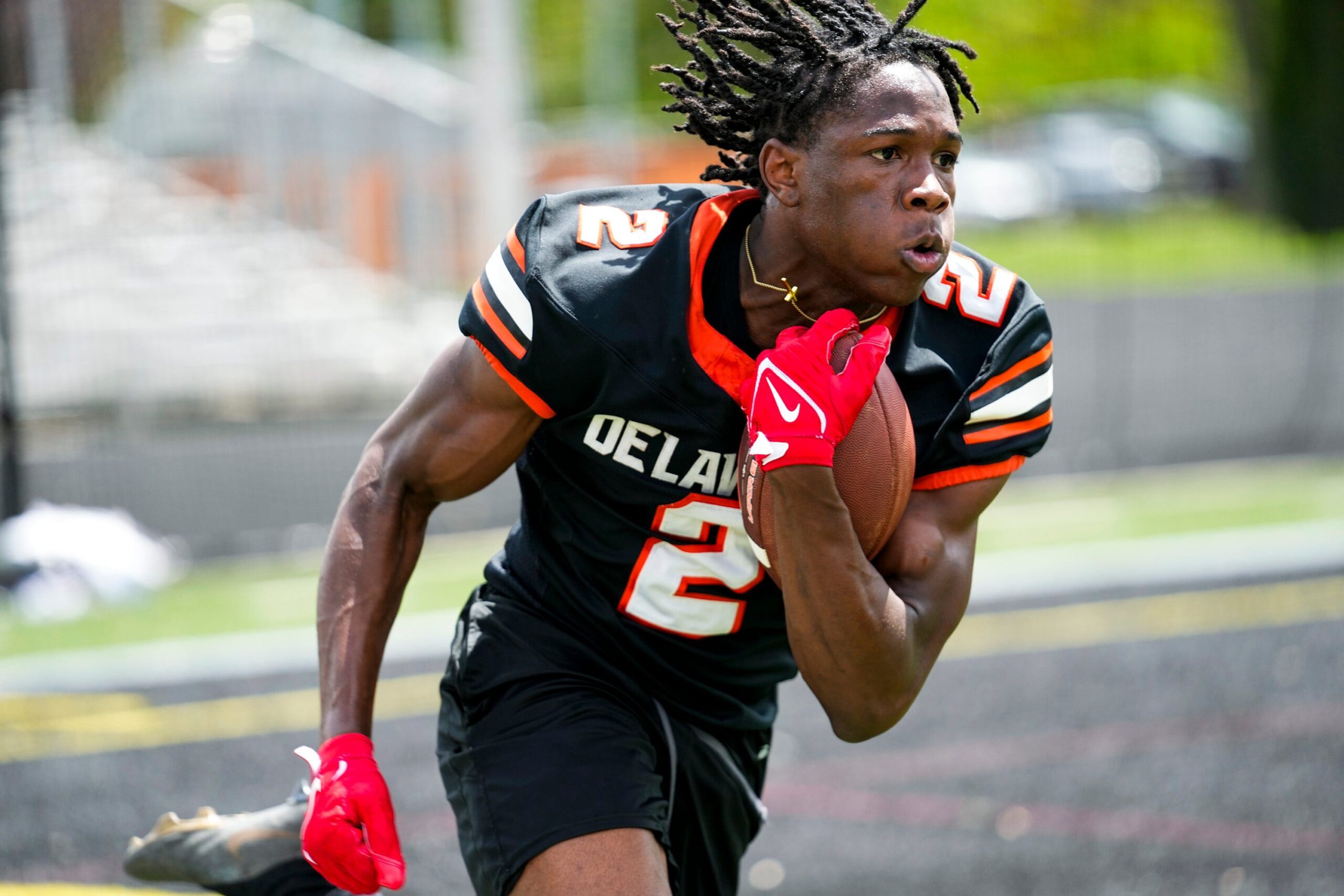 Delaware Hayes’s Favour Akih (2) runs the ball during the college football showcase at the Delaware Hayes High School on Wednesday, May 7, 2025 in Delaware, Ohio.