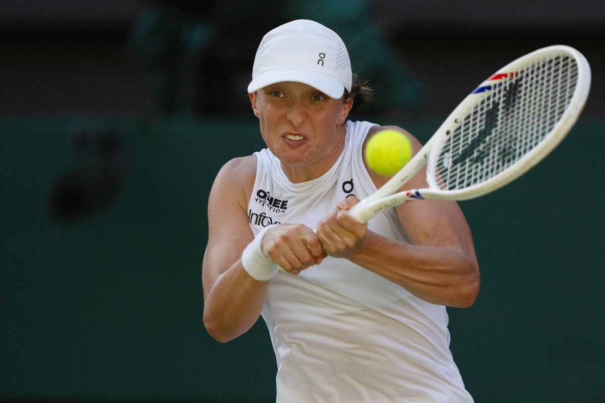 Jul 10, 2025; Wimbledon, United Kingdom; Iga Swiatek of Poland returns a shot during her match against Belinda Bencic of Switzerland on day 11 at All England Lawn Tennis and Croquet Club. Mandatory Credit: Susan Mullane-Imagn Images