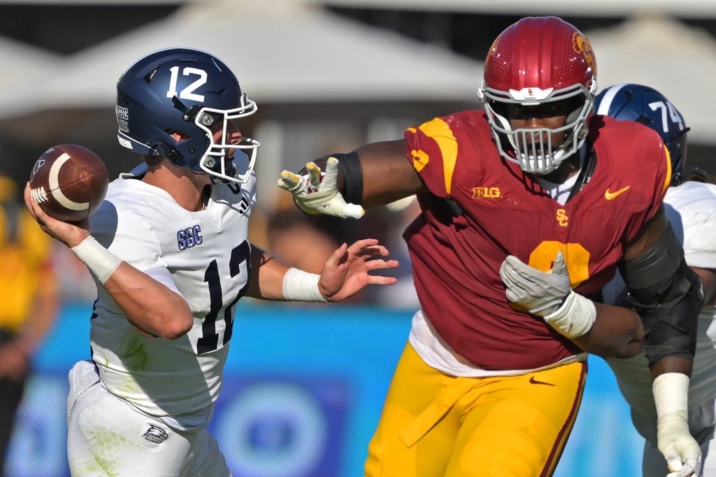 Sep 6, 2025; Los Angeles, California, USA; Georgia Southern Eagles quarterback JC French IV (12) is pressured by Trojans defensive tackle Devan Thompkins (8) during the first half at United Airlines Field at the Los Angeles Memorial Coliseum. Mandatory Credit: Jayne Kamin-Oncea-Imagn Images