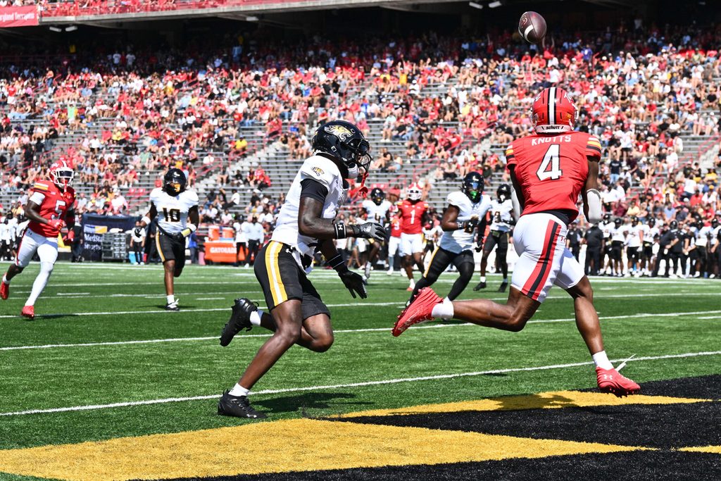 Sep 13, 2025; College Park, Maryland, USA; Maryland Terrapins wide receiver Shaleak Knotts (4) catches a touchdown pass in the first half against the Towson Tigers at SECU Stadium. Mandatory Credit: Jamie Sabau-Imagn Images