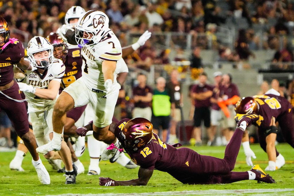 Sep 13, 2025; Tempe, Arizona, USA; Texas State Bobcats running back Lincoln Pare (7) avoids a tackle by Arizona State Sun Devils defensive back Javan Robinson (12) in the third quarter of the game between Arizona State Sun Devils and Texas State Bobcats. Mandatory Credit: Arianna Grainey-Imagn Images