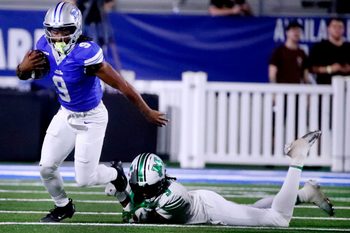 Middle Tennessee running back Jekail Middlebrook (9) deflects a tackle from Marshall linebacker Javae Gilmore (9) during MTSU's Homecoming football game on Saturday, Sept. 20, 2025.
