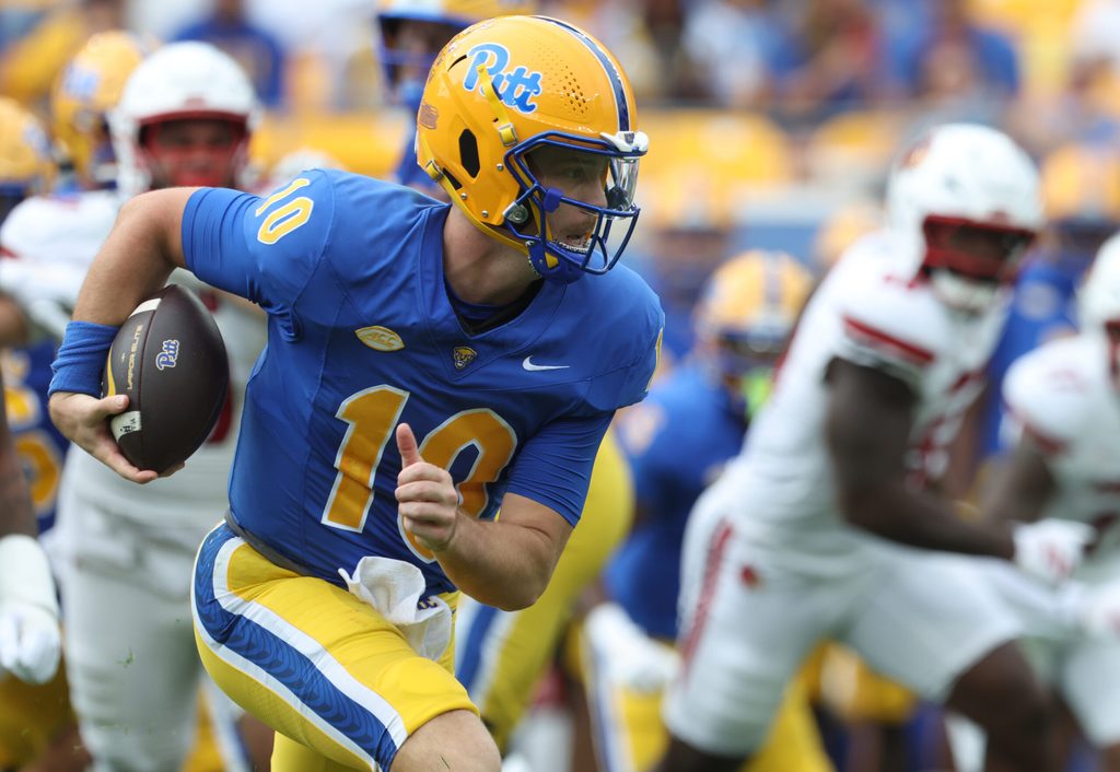 Sep 27, 2025; Pittsburgh, Pennsylvania, USA; Pittsburgh Panthers quarterback Eli Holstein (10) runs the ball against the Louisville Cardinals during the second quarter at Acrisure Stadium. Mandatory Credit: Charles LeClaire-Imagn Images