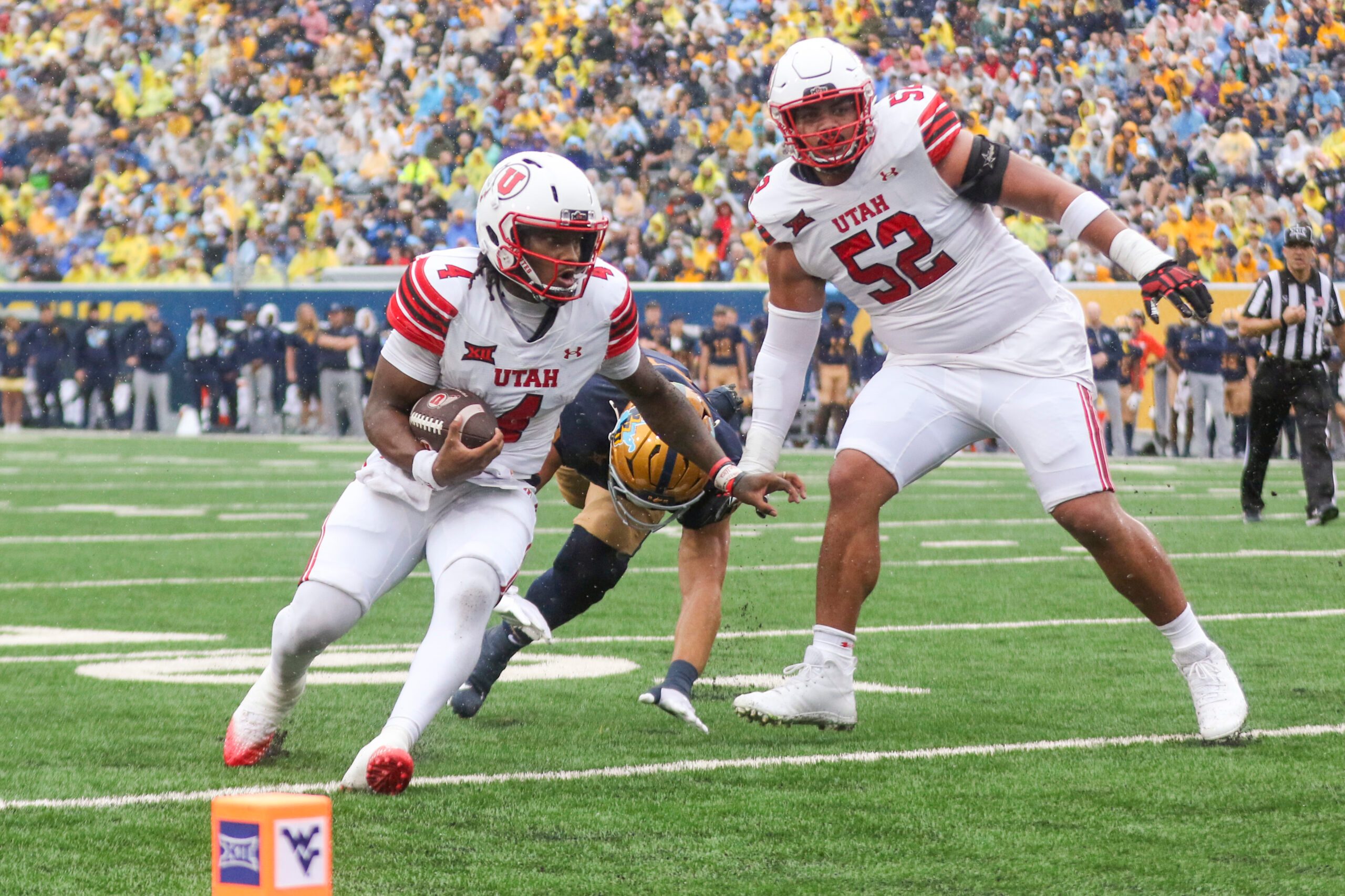 Sep 27, 2025; Morgantown, West Virginia, USA; Utah Utes quarterback Devon Dampier (4) runs the ball for a touchdown during the first quarter against the West Virginia Mountaineers at Milan Puskar Stadium. Mandatory Credit: Ben Queen-Imagn Images