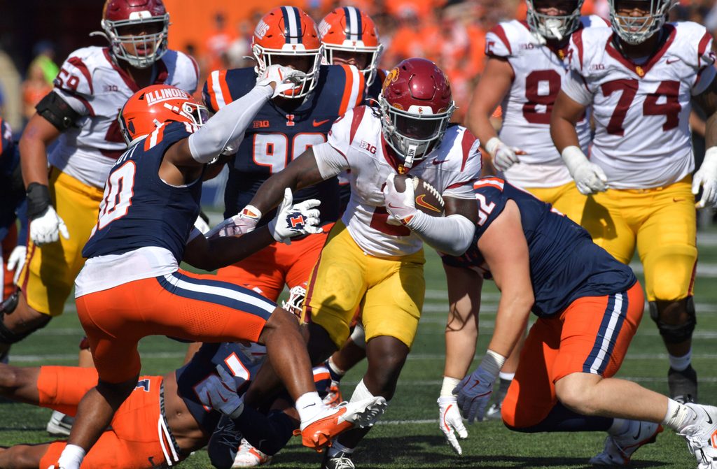 Sep 27, 2025; Champaign, Illinois, USA; Southern California Trojans running back Waymond Jordan (2) runs through the Illinois Fighting Illini defensive line during the second half at Memorial Stadium. Mandatory Credit: Ron Johnson-Imagn Images