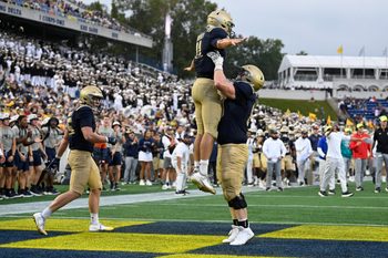 Sep 27, 2025; Annapolis, Maryland, USA;  Navy Midshipmen quarterback Blake Horvath (11) celebrates with  guard Jaylin Acevedo (66) after scoring a fourth quarter touchdown against the Rice Owls at Navy-Marine Corps Memorial Stadium. Mandatory Credit: Tommy Gilligan-Imagn Images
