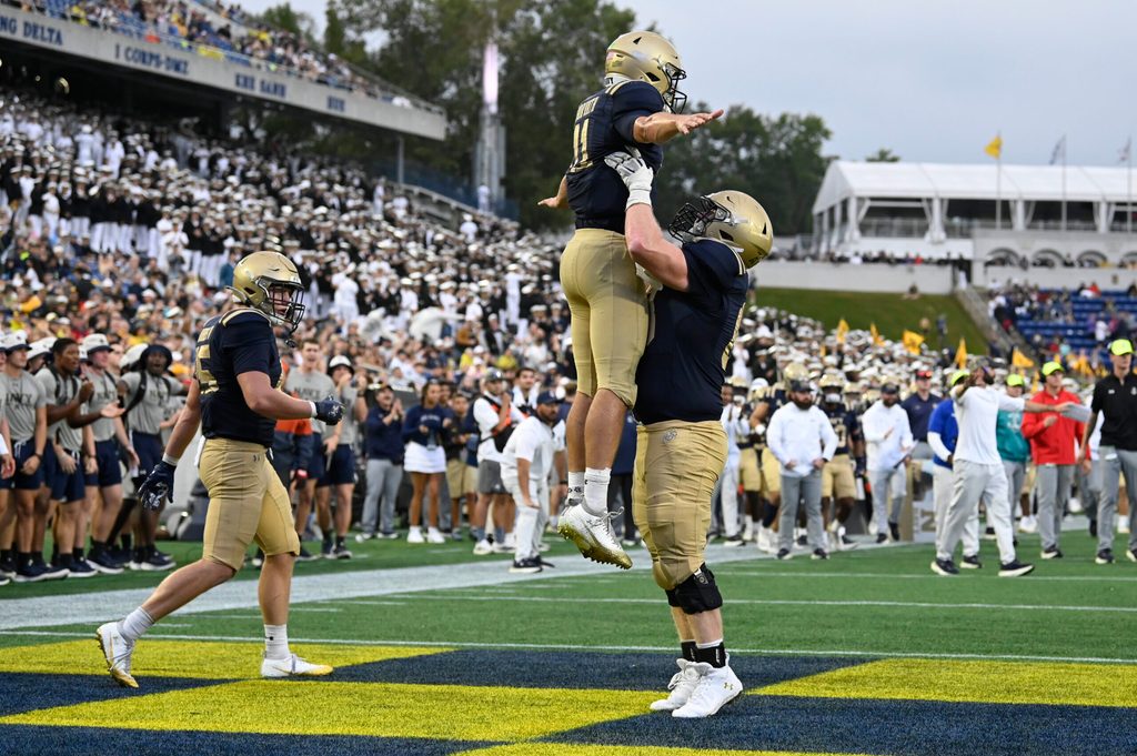 Sep 27, 2025; Annapolis, Maryland, USA; Navy Midshipmen quarterback Blake Horvath (11) celebrates with guard Jaylin Acevedo (66) after scoring a fourth quarter touchdown against the Rice Owls at Navy-Marine Corps Memorial Stadium. Mandatory Credit: Tommy Gilligan-Imagn Images