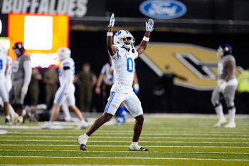 Sep 27, 2025; Boulder, Colorado, USA; Brigham Young Cougars cornerback Evan Johnson (0) celebrates a turnover in the fourth quarter against the Colorado Buffaloes at Folsom Field. Mandatory Credit: Ron Chenoy-Imagn Images
