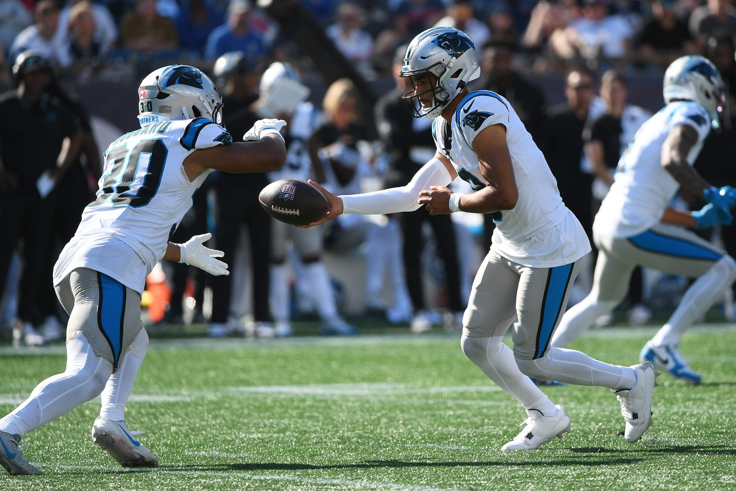 Sep 28, 2025; Foxborough, Massachusetts, USA; Carolina Panthers quarterback Bryce Young (9) hands the ball off to running back Chuba Hubbard (30) during the second half against the New England Patriots at Gillette Stadium. Mandatory Credit: Bob DeChiara-Imagn Images