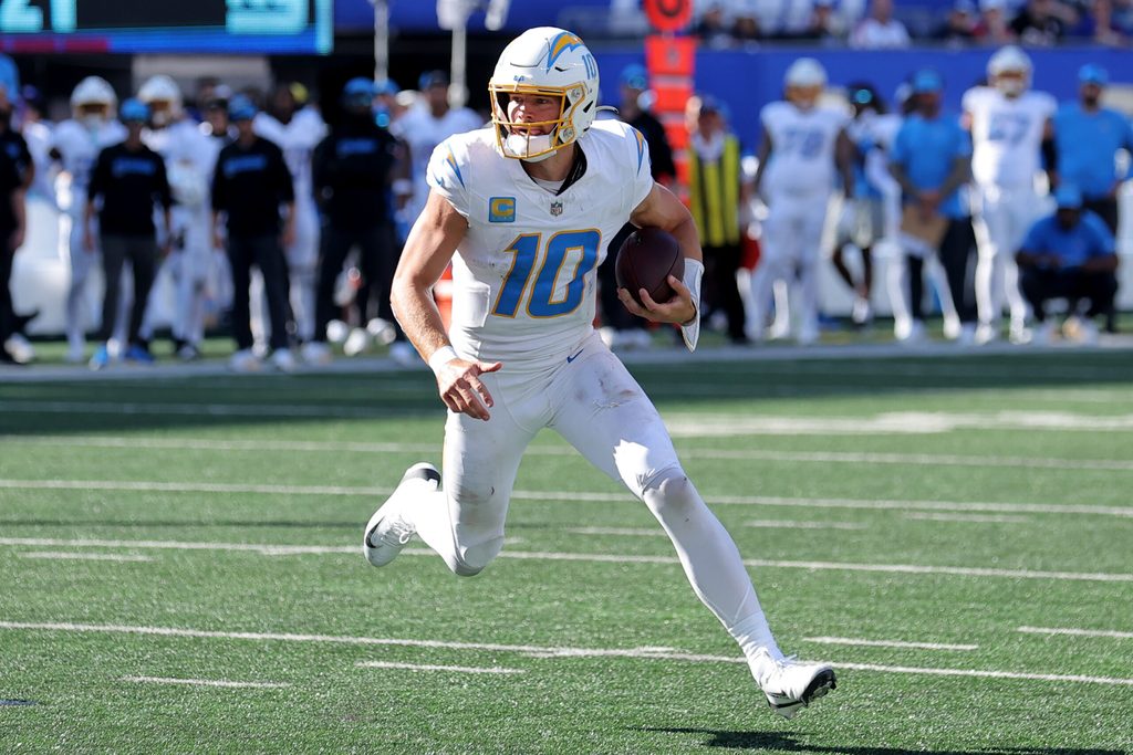Sep 28, 2025; East Rutherford, New Jersey, USA; Los Angeles Chargers quarterback Justin Herbert (10) runs with the ball against the New York Giants during the third quarter at MetLife Stadium. Mandatory Credit: Brad Penner-Imagn Images