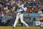 Sep 30, 2025; Los Angeles, California, USA; Los Angeles Dodgers designated hitter Shohei Ohtani (17) hits a two run home run during the sixth inning against the Cincinnati Reds during game one of the Wildcard round for the 2025 MLB playoffs at Dodger Stadium. Mandatory Credit: Jayne Kamin-Oncea-Imagn Images