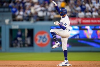 Los Angeles Dodgers shortstop Mookie Betts (50) celebrates a double in the first inning of the MLB National League Wild Card Game 2 between the Los Angeles Dodgers and the Cincinnati Reds at Dodger Stadium in Los Angeles on Wednesday, Oct. 1, 2025. The Reds were eliminated from the postseason with an 8-4 loss to the reining World Series Champions La Dodgers.