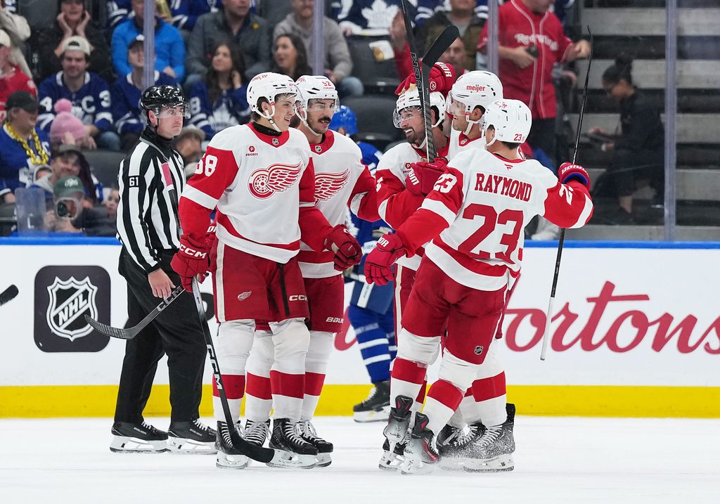 Oct 2, 2025; Toronto, Ontario, CAN; Detroit Red Wings center Dylan Larkin (71) scores a goal and celebrates with defenseman Ben Chiarot (8) against the Toronto Maple Leafs during the third period at Scotiabank Arena. Mandatory Credit: Nick Turchiaro-Imagn Images