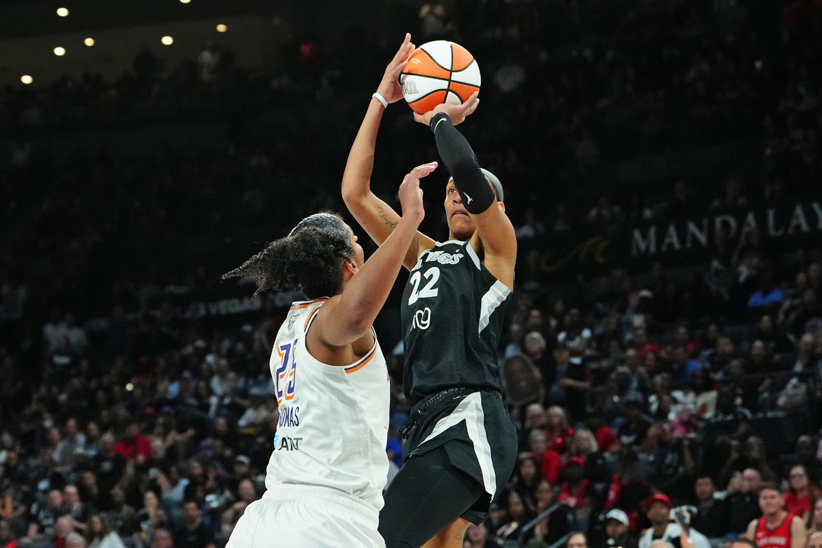 Oct 3, 2025; Las Vegas, Nevada, USA; Las Vegas Aces center A'ja Wilson (22) shoots against Phoenix Mercury forward Alyssa Thomas (25) during the fourth quarter of game one of the 2025 WNBA Finals at Michelob Ultra Arena. Mandatory Credit: Stephen R. Sylvanie-Imagn Images