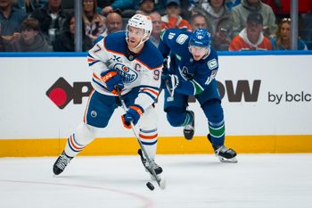 Oct 3, 2025; Vancouver, British Columbia, CAN; Edmonton Oilers forward Connor McDavid (97) handles the puck against the Vancouver Canucks in the second period at Rogers Arena. Mandatory Credit: Bob Frid-Imagn Images