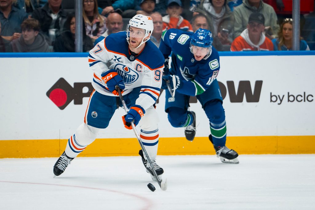 Oct 3, 2025; Vancouver, British Columbia, CAN; Edmonton Oilers forward Connor McDavid (97) handles the puck against the Vancouver Canucks in the second period at Rogers Arena. Mandatory Credit: Bob Frid-Imagn Images