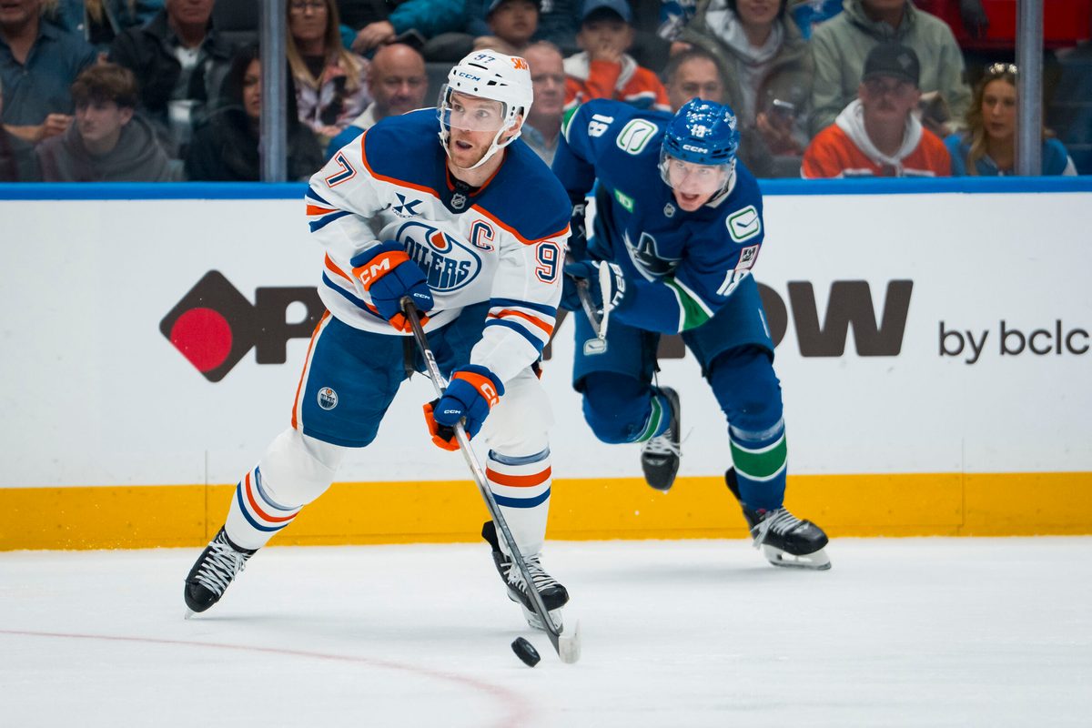 Oct 3, 2025; Vancouver, British Columbia, CAN; Edmonton Oilers forward Connor McDavid (97) handles the puck against the Vancouver Canucks in the second period at Rogers Arena. Mandatory Credit: Bob Frid-Imagn Images