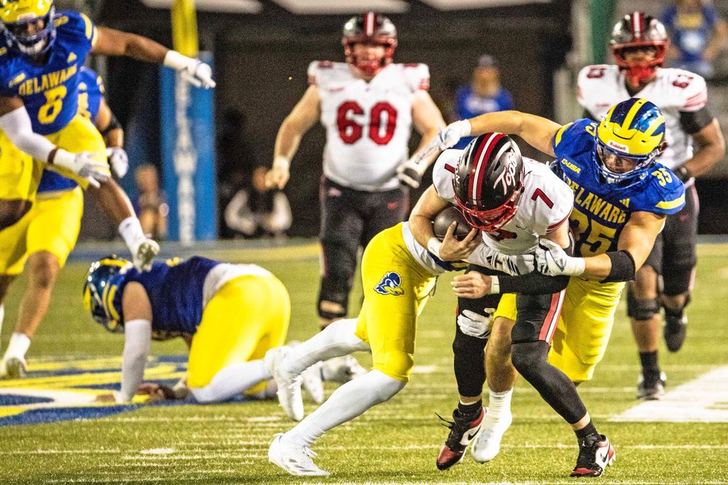 Western Kentucky quarterback Maverick McIvor (7) hangs on to the ball as Delaware Blue Hens safety KT Seay (7) and linebacker Gavin Moul (35) wrap him up for the takedown during Delaware's first home CUSA football game, which was nationally televised, at Delaware Stadium in Newark on Oct. 3, 2025. Western Kentucky won 27-24.