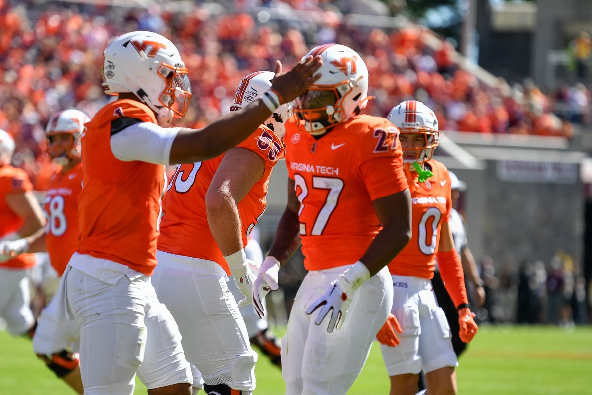 Oct 4, 2025; Blacksburg, Virginia, USA; Virginia Tech Hokies running back Marcellous Hawkins (27) celebrates with quarterback Kyron Drones (1) after scoring a touchdown against the Wake Forest Demon Deacons during the first quarter at Lane Stadium. Mandatory Credit: Brian Bishop-Imagn Images