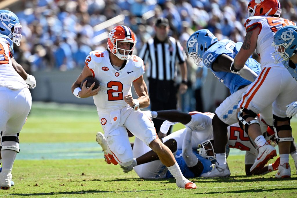 Oct 4, 2025; Chapel Hill, North Carolina, USA; Clemson Tigers quarterback Cade Klubnik (2) with the ball as North Carolina Tar Heels defensive lineman CJ Mims (92) defends in the second quarter at Kenan Stadium. Mandatory Credit: Bob Donnan-Imagn Images