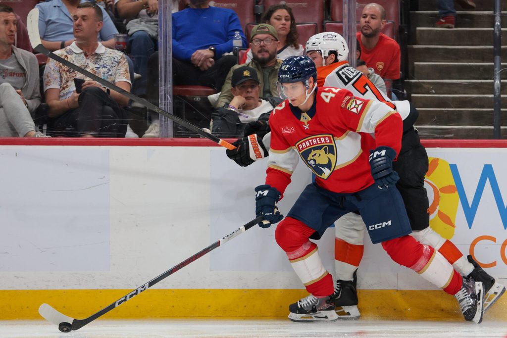 Oct 9, 2025; Sunrise, Florida, USA; Florida Panthers defenseman Gustav Forsling (42) moves the puck against Philadelphia Flyers right wing Tyson Foerster (71) during the third period at Amerant Bank Arena. Mandatory Credit: Sam Navarro-Imagn Images