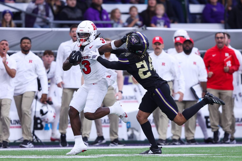 Oct 10, 2025; Seattle, Washington, USA; Rutgers Scarlet Knights running back Antwan Raymond (3) stiff arms Washington Huskies running back Adam Mohammed (24) during the first half at Husky Stadium. Mandatory Credit: Kevin Ng-Imagn Images