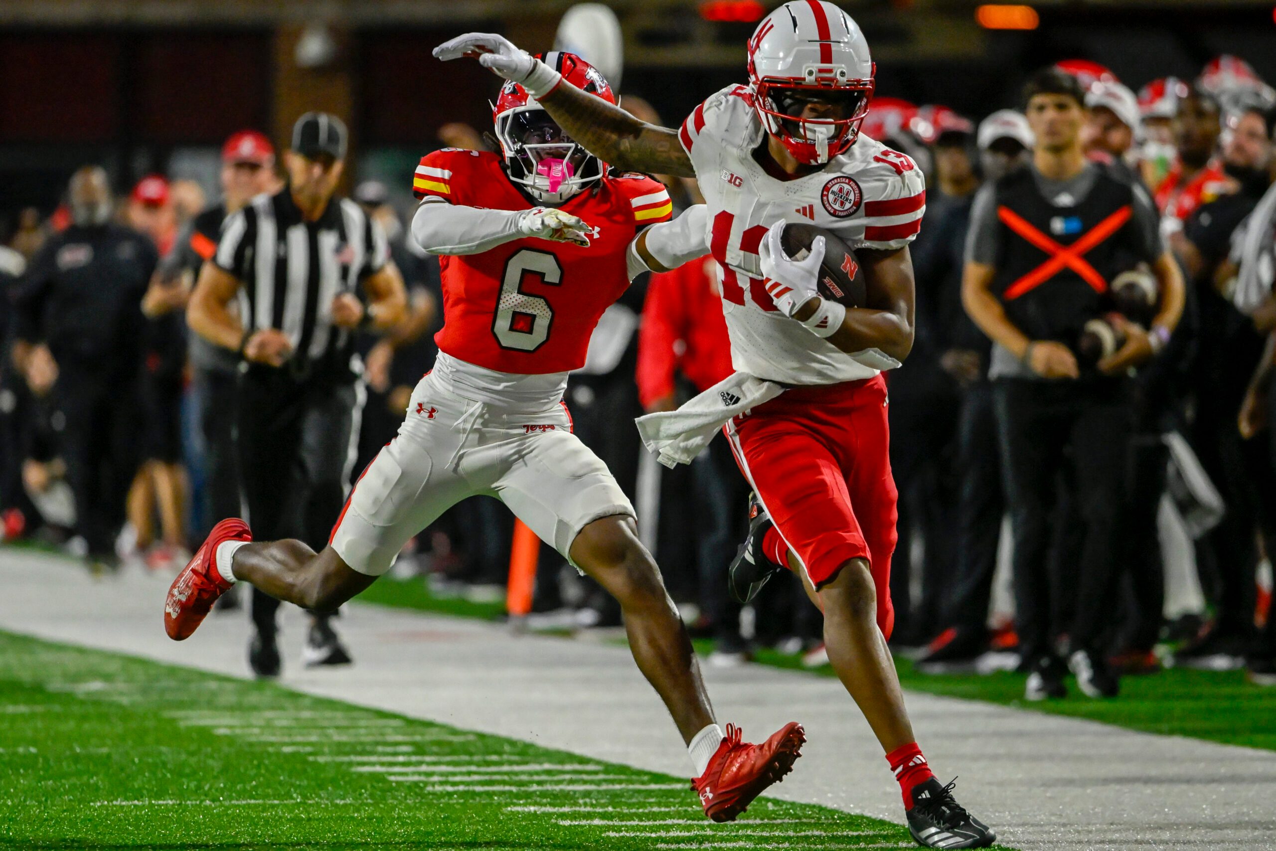 Oct 11, 2025; College Park, Maryland, USA;  Nebraska Cornhuskers wide receiver Nyziah Hunter (13) runs for a first down as Maryland Terrapins defensive back Dontay Joyner (6) defends during the second half at SECU Stadium. Mandatory Credit: Tommy Gilligan-Imagn Images