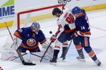 Oct 11, 2025; Elmont, New York, USA; Washington Capitals left wing Pierre-Luc Dubois (80) plays the puck against New York Islanders goaltender Ilya Sorokin (30) and center Bo Horvat (14) during the third period at UBS Arena. Mandatory Credit: Brad Penner-Imagn Images