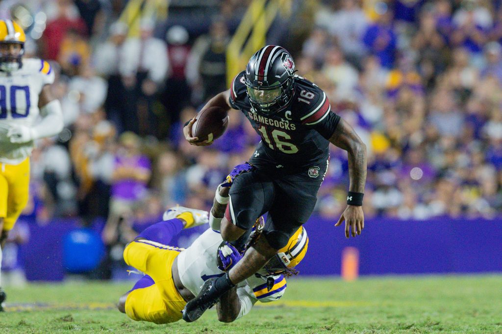 Oct 11, 2025; Baton Rouge, Louisiana, USA; LSU Tigers linebacker Harold Perkins Jr. (7) tackles South Carolina Gamecocks quarterback Lanorris Sellers (16) during the second half at Tiger Stadium. Mandatory Credit: Stephen Lew-Imagn Images