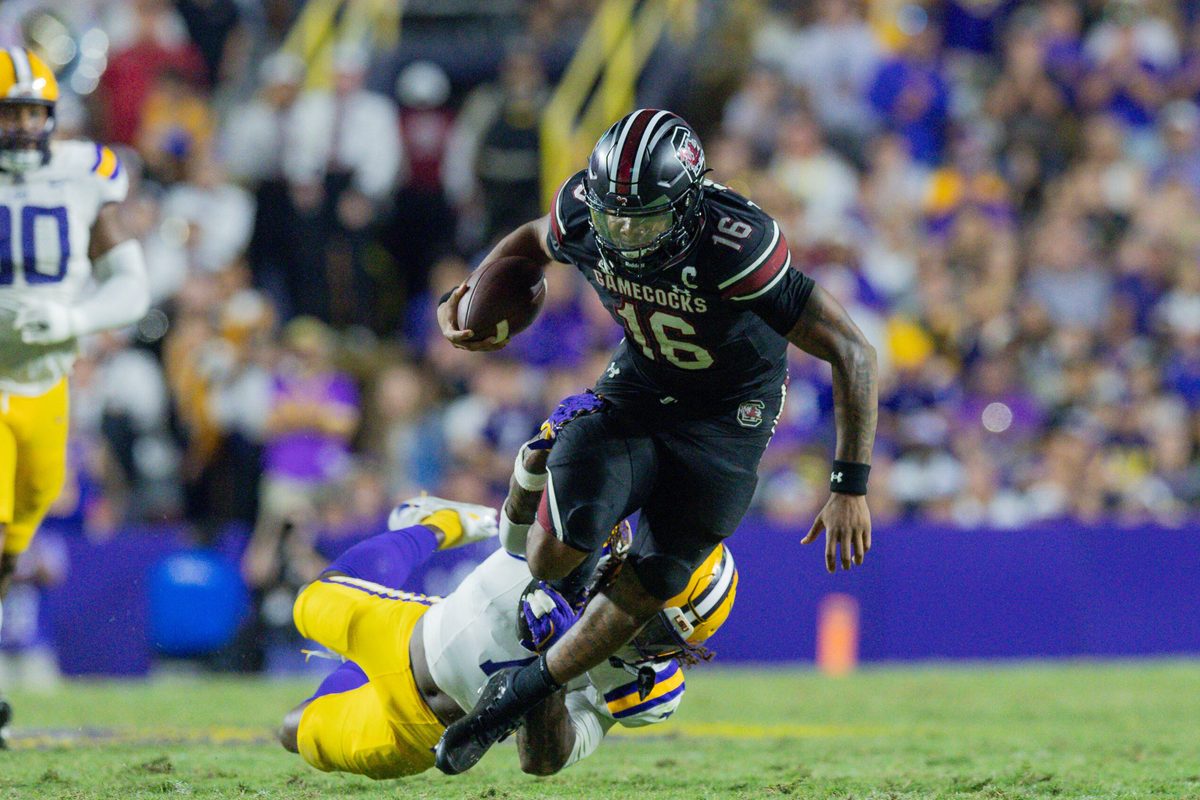 Oct 11, 2025; Baton Rouge, Louisiana, USA; LSU Tigers linebacker Harold Perkins Jr. (7) tackles South Carolina Gamecocks quarterback Lanorris Sellers (16) during the second half at Tiger Stadium. Mandatory Credit: Stephen Lew-Imagn Images