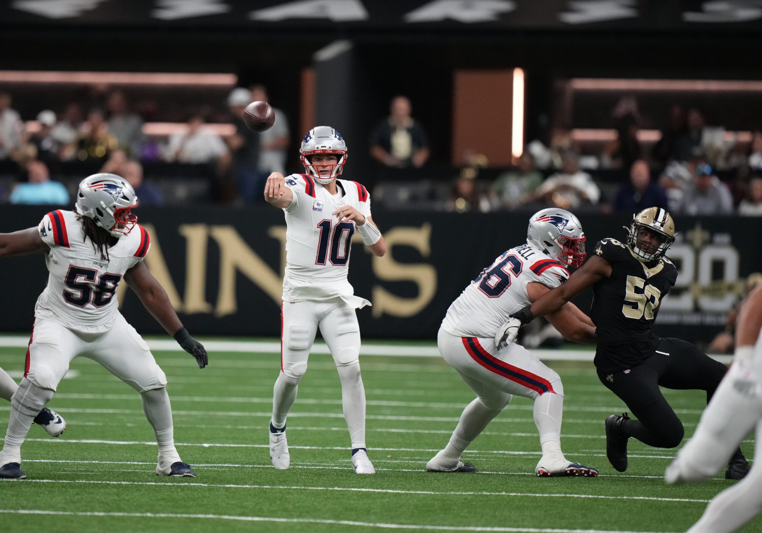 Oct 12, 2025; New Orleans, Louisiana, USA; New England Patriots quarterback Drake Maye (10) throws downfield during the second half against the New Orleans Saints at Caesars Superdome. Mandatory Credit: Matthew Hinton-Imagn Images