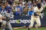 Milwaukee Brewers second baseman Brice Turang (2) grounds out to shallow infield to Los Angeles Dodgers first baseman Freddie Freeman (5) during the eighth inning of the National League Championship Series game October 13, 2025 at American Family Field in Milwaukee, Wisconsin.