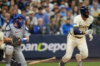 Milwaukee Brewers second baseman Brice Turang (2) grounds out to shallow infield to Los Angeles Dodgers first baseman Freddie Freeman (5) during the eighth inning of the National League Championship Series game October 13, 2025 at American Family Field in Milwaukee, Wisconsin.