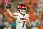 Oct 17, 2025; Miami Gardens, Florida, USA; Louisville Cardinals quarterback Miller Moss (7) throws the football against the Miami Hurricanes during the second quarter at Hard Rock Stadium. Mandatory Credit: Sam Navarro-Imagn Images