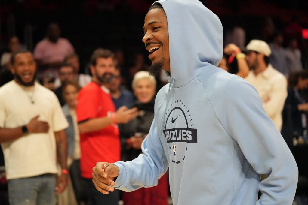Oct 17, 2025; Miami, Florida, USA; Memphis Grizzlies guard Ja Morant (12) who did not play due to injury, leaves the court after the Memphis Grizzlies defeat the Miami Heat at Kaseya Center. Mandatory Credit: Jim Rassol-Imagn Images