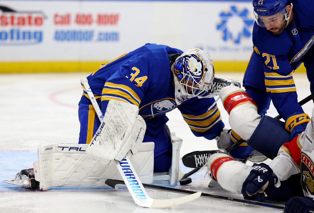 Oct 18, 2025; Buffalo, New York, USA; Buffalo Sabres goaltender Alex Lyon (34) makes a save and looks to cover up the puck during the first period against the Florida Panthers at KeyBank Center. Mandatory Credit: Timothy T. Ludwig-Imagn Images
