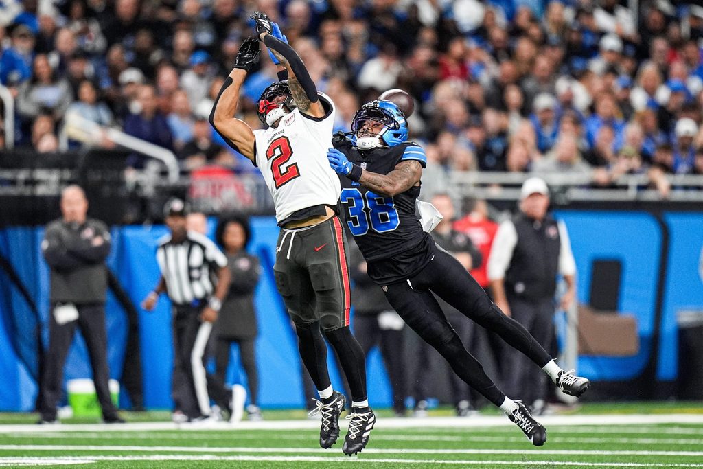 Detroit Lions cornerback Nick Whiteside (38) tackles Tampa Bay Buccaneers wide receiver Emeka Egbuka (2) during the second half at Ford Field in Detroit on Monday, Oct. 20, 2025.