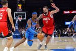 Oct 21, 2025; Oklahoma City, Oklahoma, USA; Oklahoma City Thunder guard Shai Gilgeous-Alexander (2) drives to the basket beside Houston Rockets center Steven Adams (12) during the first half at Paycom Center. Mandatory Credit: Alonzo Adams-Imagn Images