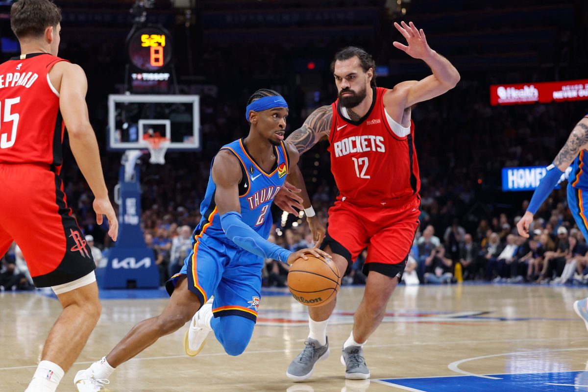 Oct 21, 2025; Oklahoma City, Oklahoma, USA; Oklahoma City Thunder guard Shai Gilgeous-Alexander (2) drives to the basket beside Houston Rockets center Steven Adams (12) during the first half at Paycom Center. Mandatory Credit: Alonzo Adams-Imagn Images