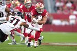 Oct 19, 2025; Santa Clara, California, USA; San Francisco 49ers running back Christian McCaffrey (center) carries the ball against Atlanta Falcons safety Xavier Watts (31) during the second quarter at Levi's Stadium. Mandatory Credit: Darren Yamashita-Imagn Images