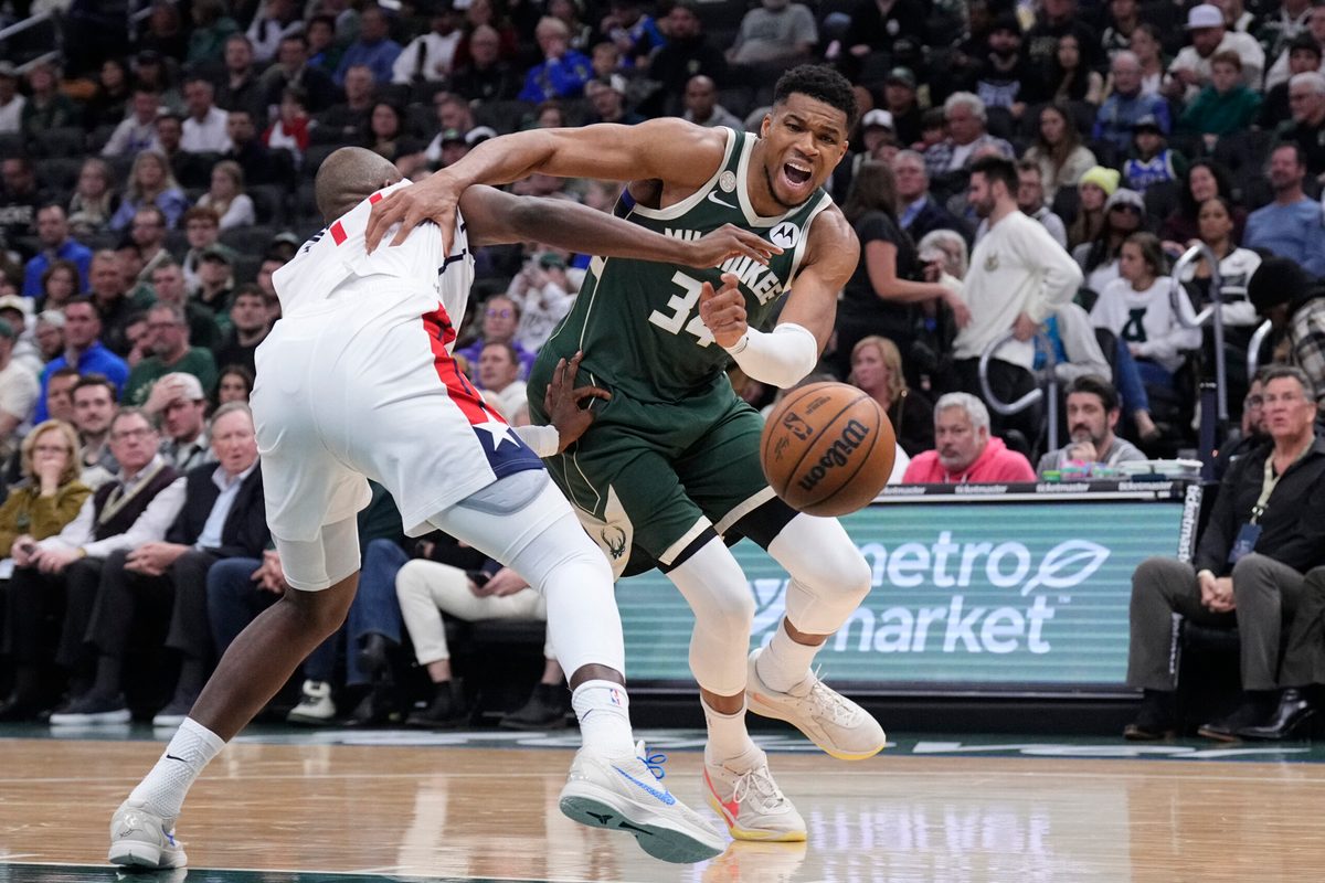 Oct 22, 2025; Milwaukee, Wisconsin, USA; Milwaukee Bucks forward Giannis Antetokounmpo (34) drives against Washington Wizards forward Khris Middleton (22) in the first half at Fiserv Forum. Mandatory Credit: Michael McLoone-Imagn Images