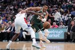 Oct 22, 2025; Milwaukee, Wisconsin, USA; Milwaukee Bucks forward Giannis Antetokounmpo (34) drives against Washington Wizards forward Khris Middleton (22) in the first half at Fiserv Forum. Mandatory Credit: Michael McLoone-Imagn Images