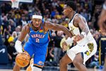 Oct 23, 2025; Indianapolis, Indiana, USA;  Oklahoma City Thunder guard Shai Gilgeous-Alexander (2) dribbles the ball while Indiana Pacers guard Bennedict Mathurin (00) defends in the second half at Gainbridge Fieldhouse. Mandatory Credit: Trevor Ruszkowski-Imagn Images