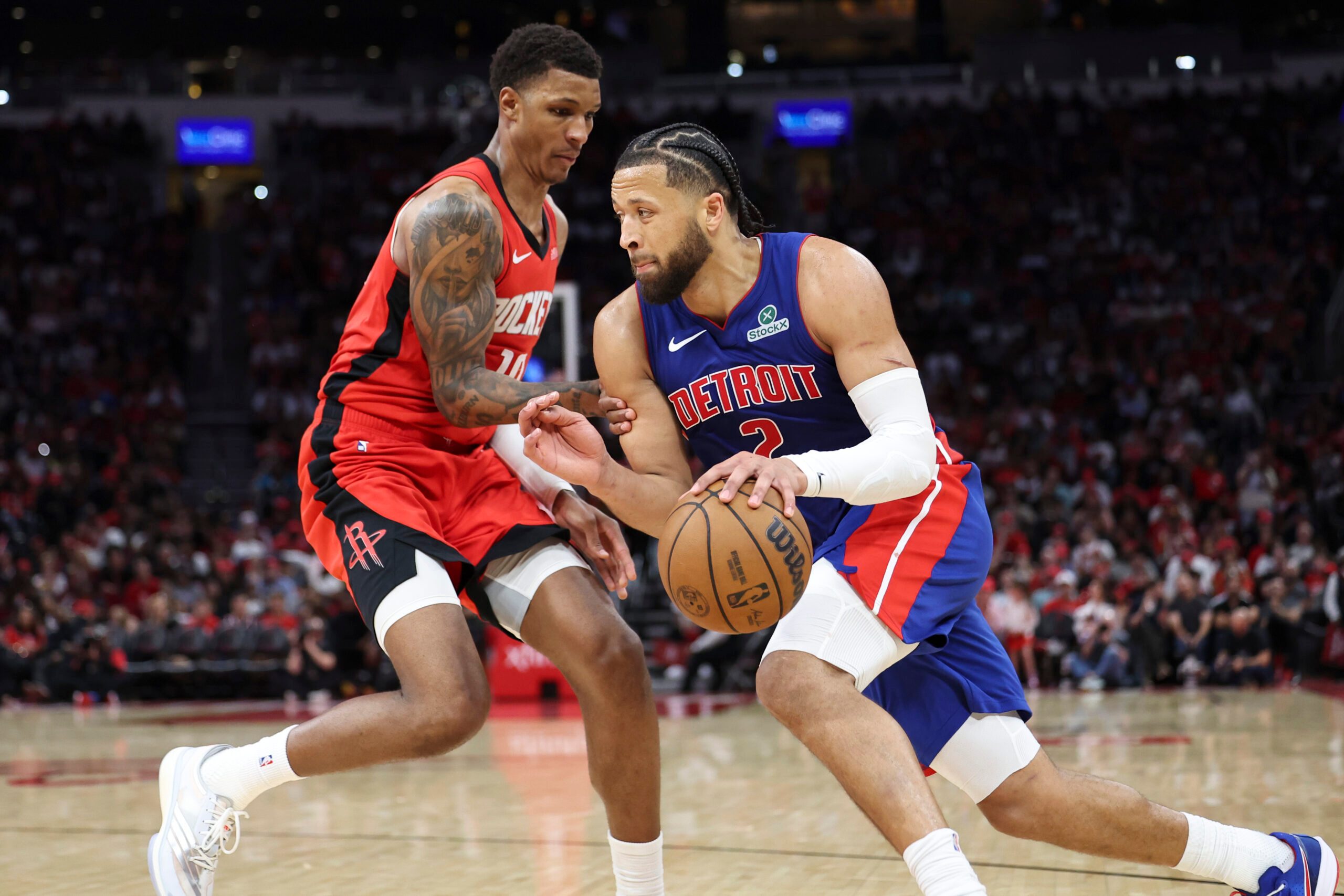 Oct 24, 2025; Houston, Texas, USA; Detroit Pistons guard Cade Cunningham (2) drives with the ball as Houston Rockets forward Jabari Smith Jr. (10) defends during the fourth quarter at Toyota Center. Mandatory Credit: Troy Taormina-Imagn Images