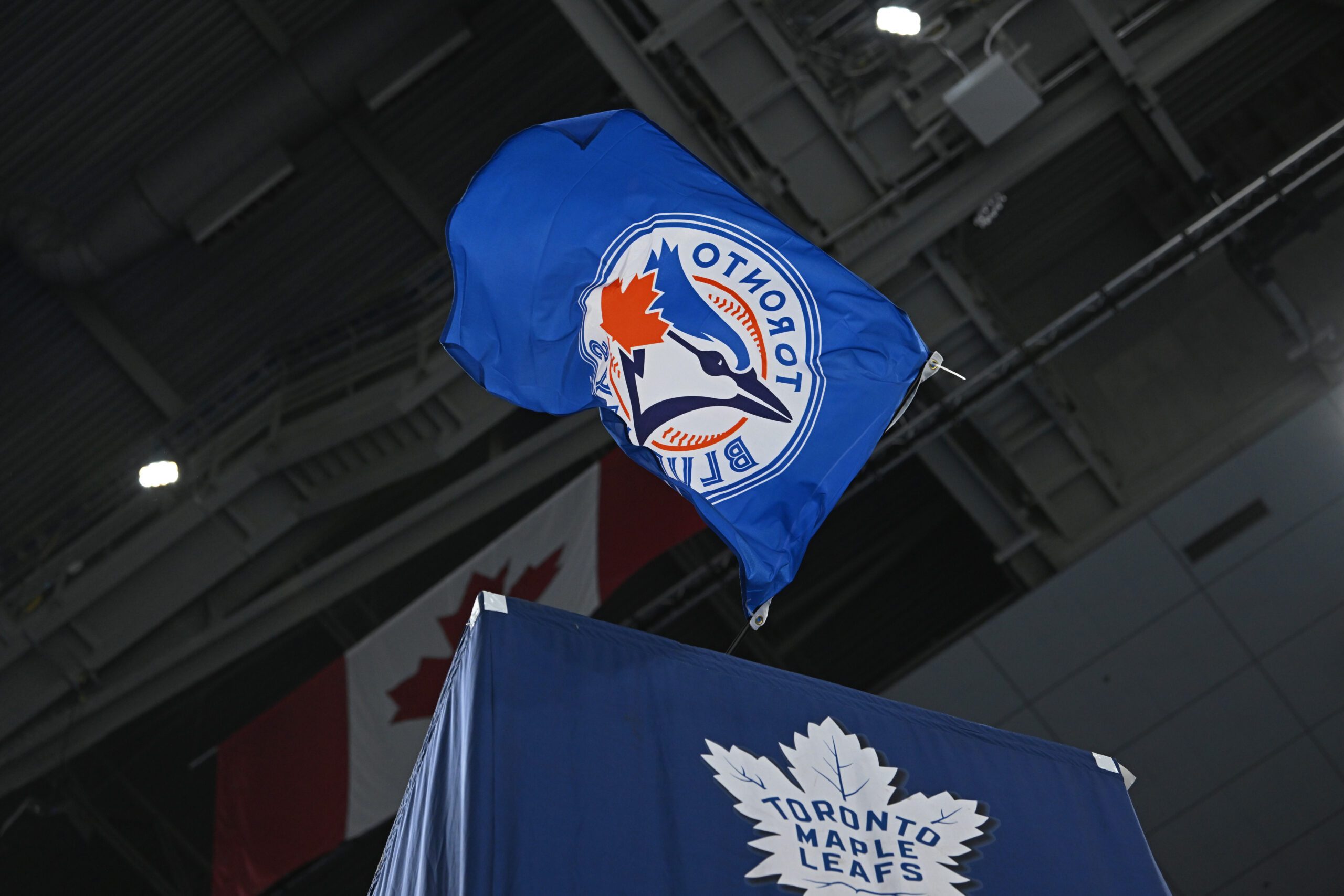 Oct 25, 2025; Toronto, Ontario, CAN; The Toronto Blue Jays flag is waved by the Toronto Maple Leafs against the Buffalo Sabres at Scotiabank Arena. Mandatory Credit: Gerry Angus-Imagn Images
