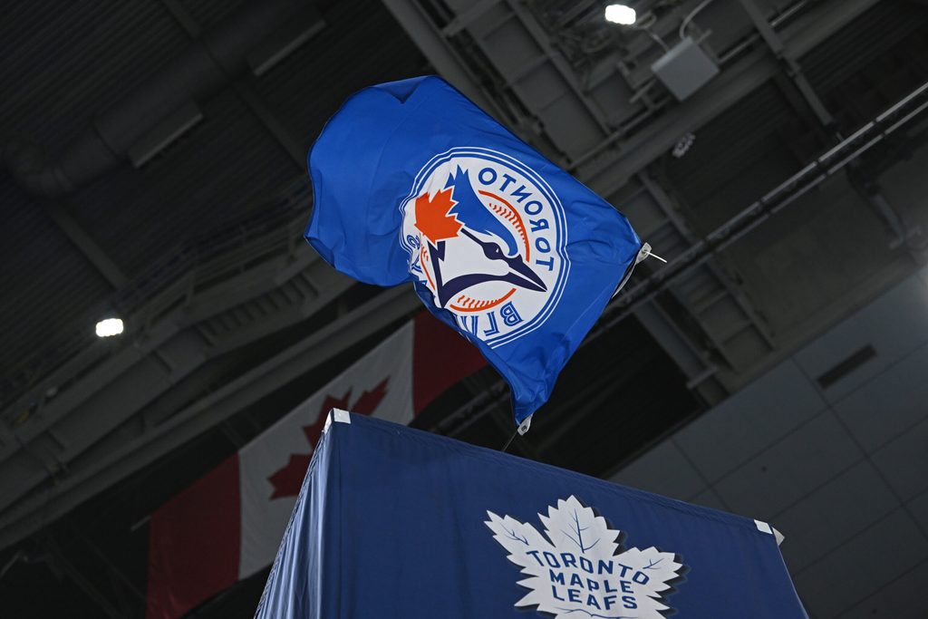Oct 25, 2025; Toronto, Ontario, CAN; The Toronto Blue Jays flag is waved by the Toronto Maple Leafs against the Buffalo Sabres at Scotiabank Arena. Mandatory Credit: Gerry Angus-Imagn Images
