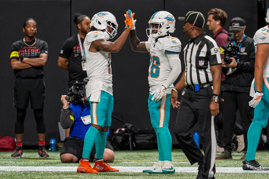 Oct 26, 2025; Atlanta, Georgia, USA; Miami Dolphins wide receiver Jaylen Waddle (17) reacts with running back De'Von Achane (28)  after running for a touchdown past Atlanta Falcons safety Jessie Bates III (3) during the second half at Mercedes-Benz Stadium. Mandatory Credit: Dale Zanine-Imagn Images