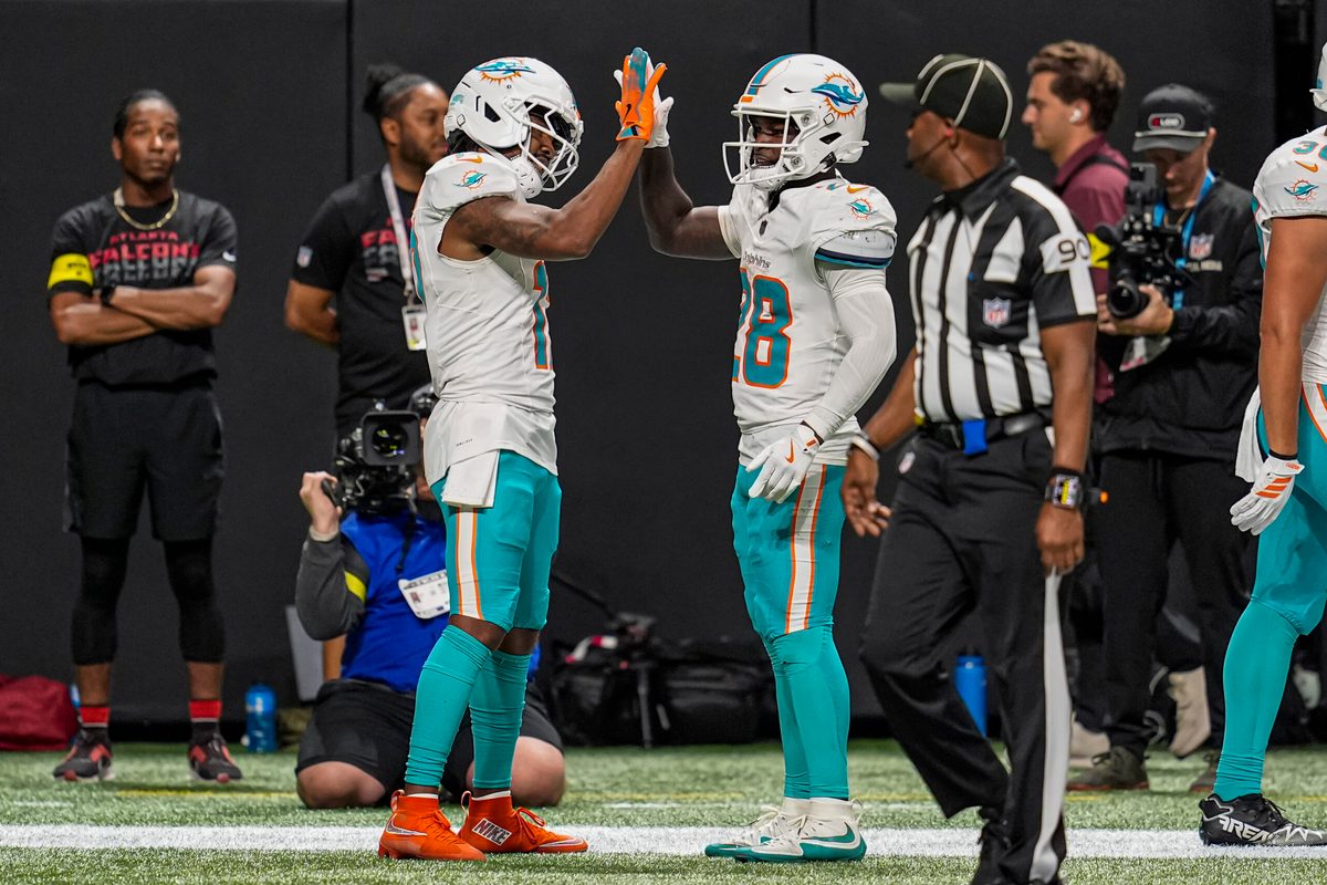 Oct 26, 2025; Atlanta, Georgia, USA; Miami Dolphins wide receiver Jaylen Waddle (17) reacts with running back De'Von Achane (28) after running for a touchdown past Atlanta Falcons safety Jessie Bates III (3) during the second half at Mercedes-Benz Stadium. Mandatory Credit: Dale Zanine-Imagn Images